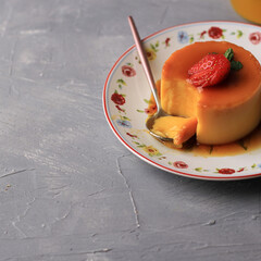 Pudding Caramel Custard with Strawberry on Cement Background