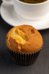 Soft and fresh fragrant wheat cupcake on a black stone