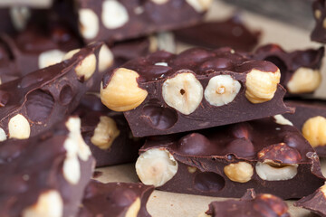 Pieces of homemade milk chocolate with lots of hazelnuts