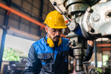 Business of factory production and construction work technology, Professional engineer person wearing safety helmet hard hat to using machinery equipment of industry facility in manufacturing plant