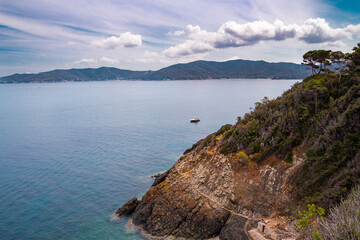 Pathway with small steps carved in stone to little Crocetta beach, situated near Marciana Marina, Elba island, Italy