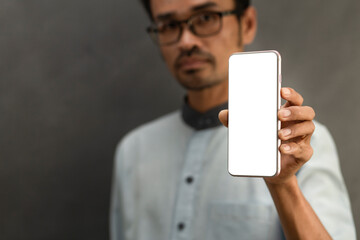 Hand holding  smartphone with transparent screen and gray background , smartphone frameless application design concept and PNG file