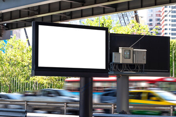 Outdoor black pole light box billboard with mock up white screen on footpath with car on road...