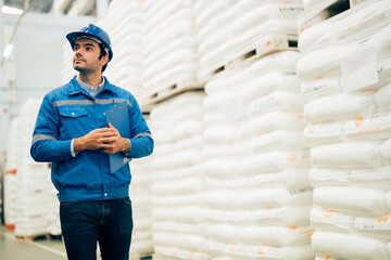 Smart engineer man worker wearing safety helmet doing stocktaking of product management in...