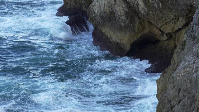 Waves crashing against the rocks on the cliffs of northern Spain, Asturias, take slowmotion.
