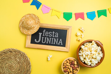 Festa Junina party background with popcorn, peanuts and chalkboard. Brazilian summer harvest festival concept. Top view from above