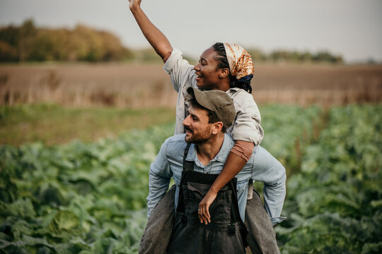 Romantic countryside couple having fun during a workday in the farm field.