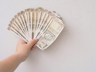 hand with money Woman hand hold India Rupee Banknote