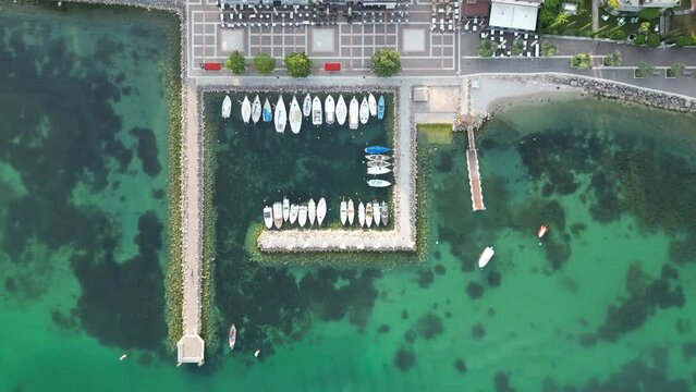 Boats For Rent Docked On The Marina In Cisano, Lake Garda, Italy. aerial topdown