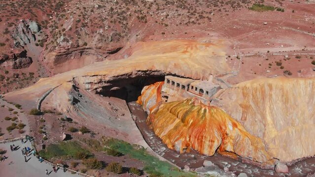 Aerial over the Puente del Inca which is a natural arch over the Las Cuevas River in the Mendoza Province, Argentina. Drone dolly forward