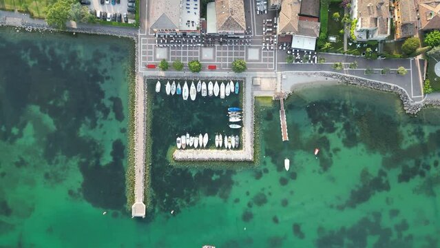 Overhead View Of Boats In The Port of Cisano In Lake Garda, Italy. - aerial