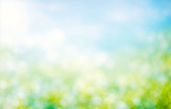 Summer background of blue and green, blurred foilage and sky with bright bokeh. Blurry Abstract spring and summer background