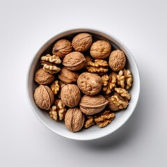 Peeled walnuts on a white bowl white background. a top view. Generative AI.