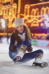 Smile, ice skating and woman tie shoes on rink to start fitness, exercise and workout at night....
