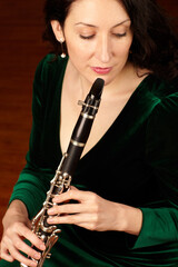 Music, performance and woman playing clarinet, orchestra musician, creative talent and classical show. Art, focus and female artist, professional concert clarinetist with creativity and inspiration.