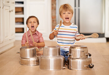 Children, playing and pots for music or noise in family home or kitchen for happiness, fun and...
