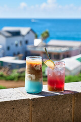 Summer drinks and cocktails on the background of the sea at the resort.