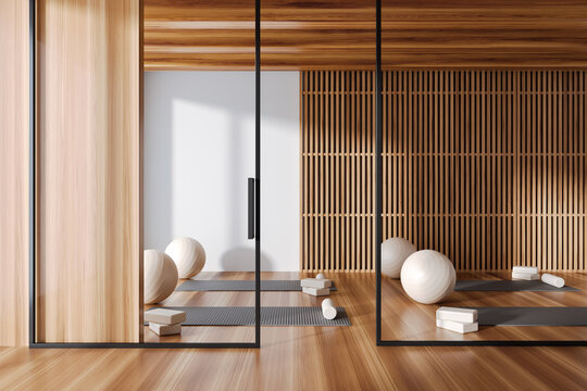 Stylish gym class interior with sport equipment and glass partition