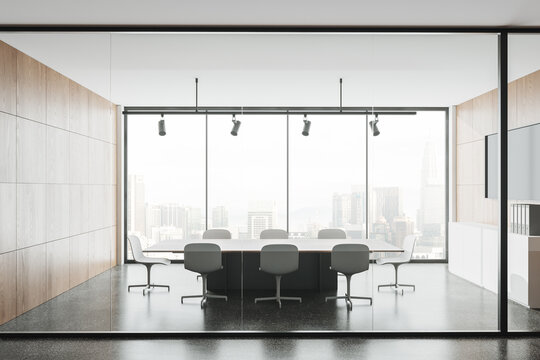 Light meeting room interior with table and chairs, panoramic window