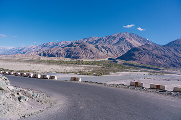 road with two sides are high mountains, and blue sky. Beautiful scenery on the way to pangong lake, Leh, Ladakh, Jammu and Kashmir, India