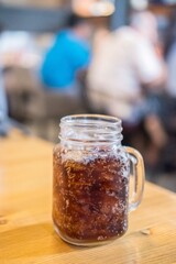 A glass of Cola on the table
