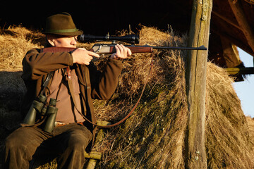 Hunter, safari gun and man shooting with aim at sunrise at a wildlife lookout for hunting. Target,...