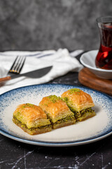 Baklava with pistachio on a dark background. Traditional Turkish baklava. Close up