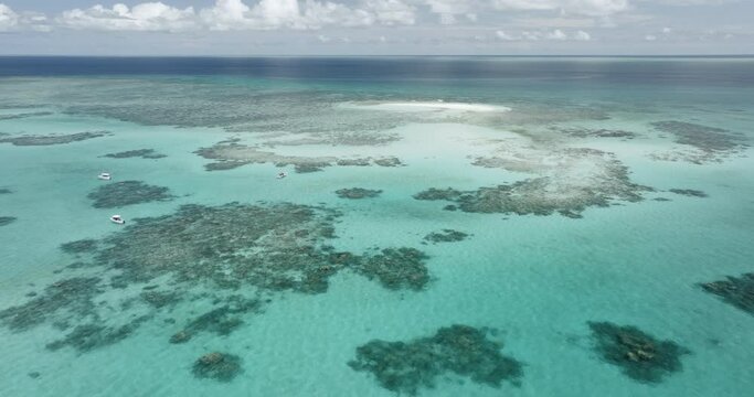 Boats in the ocean near Vlasoff Cay on the Great Barrier Reef in Far North Queensland, Australia