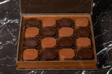 Packed madlen chocolate. Milky and bitter square shape chocolate. Gift or celebration. Close up