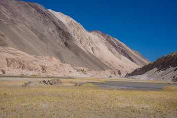 beautiful scenery, the river flows between the foothills of the mountains in the valley at ladakh, India