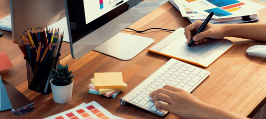 Graphic designer work on computer laptop and with graphic drawing pen while brainstorming unique...