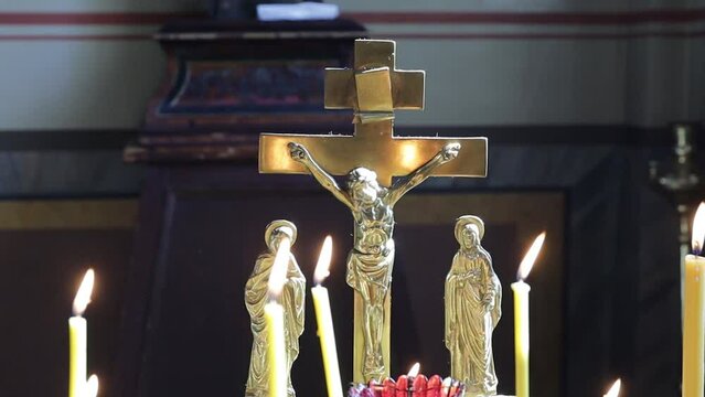 Christian cross in church with candles