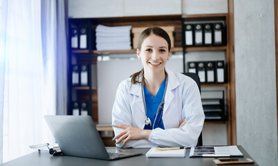 Smiling doctor or consultant sitting at a desk his neck looking at the camera