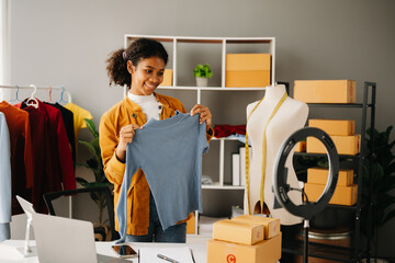 Fashion blogger concept, Young African women selling clothes on video streaming.Startup small...