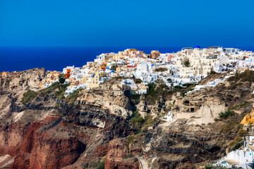 Fototapeta na wymiar The Rocky Headland with the Beautiful Village of Oia on Santorini, Greece