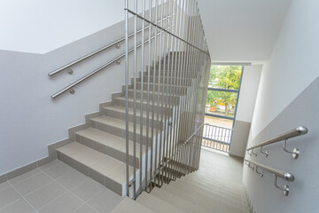 Staircase with stainless steel bar protection installed.