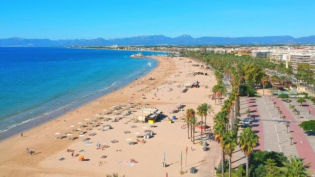 Beach in Catalan city Salou, Spain, Europe. Sea and palm in Catalonia