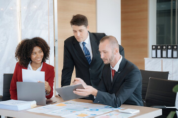 Mature business leader consultant talking to team of diverse colleagues listening to white CEO. professional investor working new start up project. 