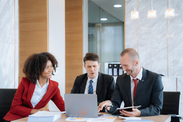 Mature business leader consultant talking to team of diverse colleagues listening to white CEO. professional investor working new start up project. 