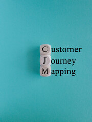 CJM customer journey mapping symbol. Concept words CJM customer journey mapping on wooden cubes on a beautiful blue background. Business and CJM customer journey mapping concept. Copy space.