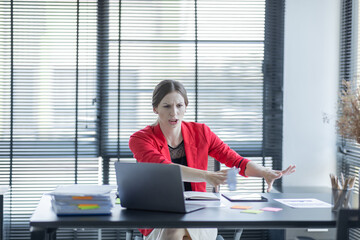 Portrait of tired american business Asian woman work with documents tax laptop computer in office....