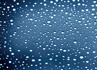 Naklejka na ściany i meble Water drops on a blue background, abstract background