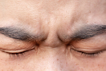 The eyebrows of a person who is stressed