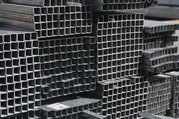 Obraz premium Stack of rolled metal products, perspective view of steel pipes of rectangular cross-section