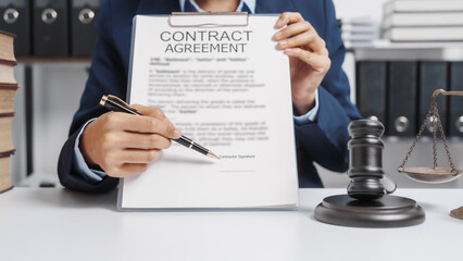 Young single female lawyer asian people in formal suit real estate working law book and contract documents, Arguments for Defense Strategy. Fight for Freedom. Supporting Evidence.