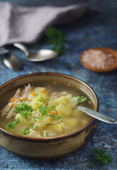 A bowl with chicken soup with pasta