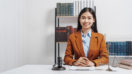 Young single female lawyer asian people in formal suit real estate working law book and contract documents, Arguments for Defense Strategy. Fight for Freedom. Supporting Evidence.