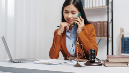 Young single female lawyer asian people in formal suit real estate working law book and contract documents, Arguments for Defense Strategy. Fight for Freedom. Supporting Evidence.