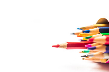 Many pencil colors in box isolated on white paper background.Red pencil offside each other.Leader business concept with copy space.Blank or empty clipboard.Red sanding out.Leadership and independence.