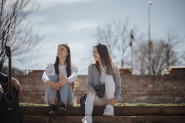 Two girls sitting at the park